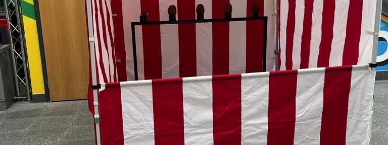Coconut shy side stall at an outdoor funfair