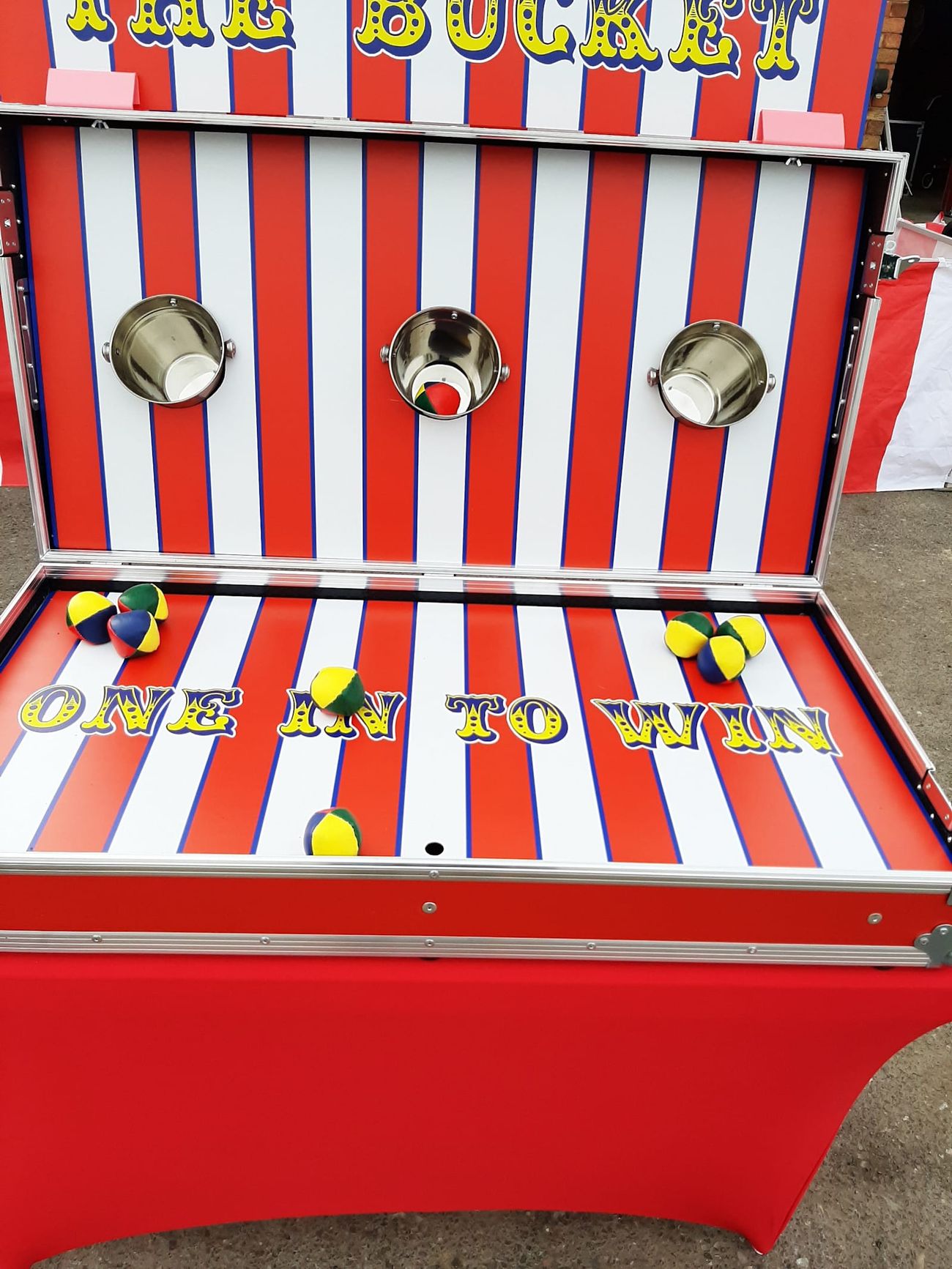 The Ball in a Bucket game unit on its trestle table, with the backboard and buckets ready for players