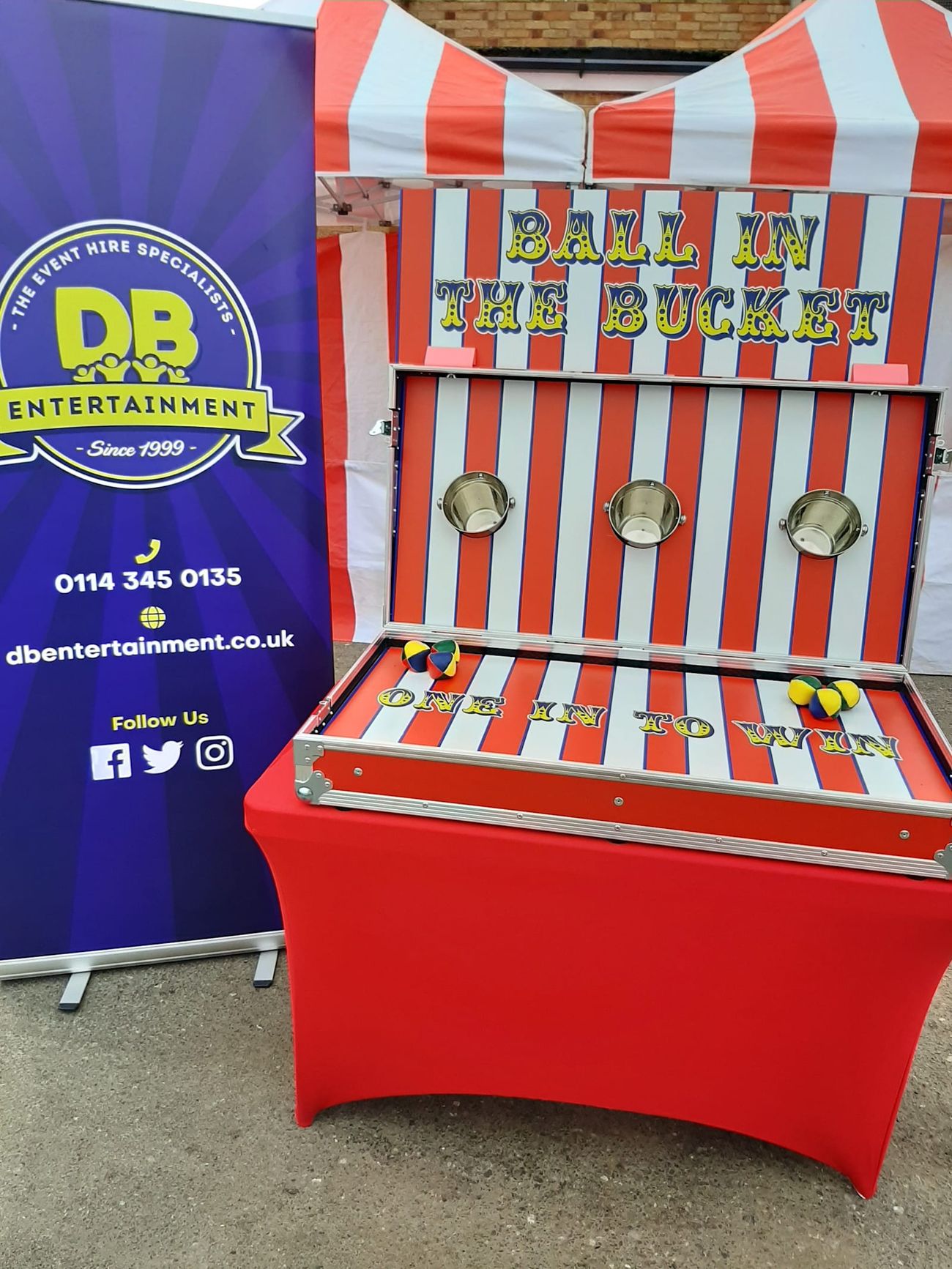 The Ball in a Bucket stall set up on hard standing, showing the game works on paved sites and indoors