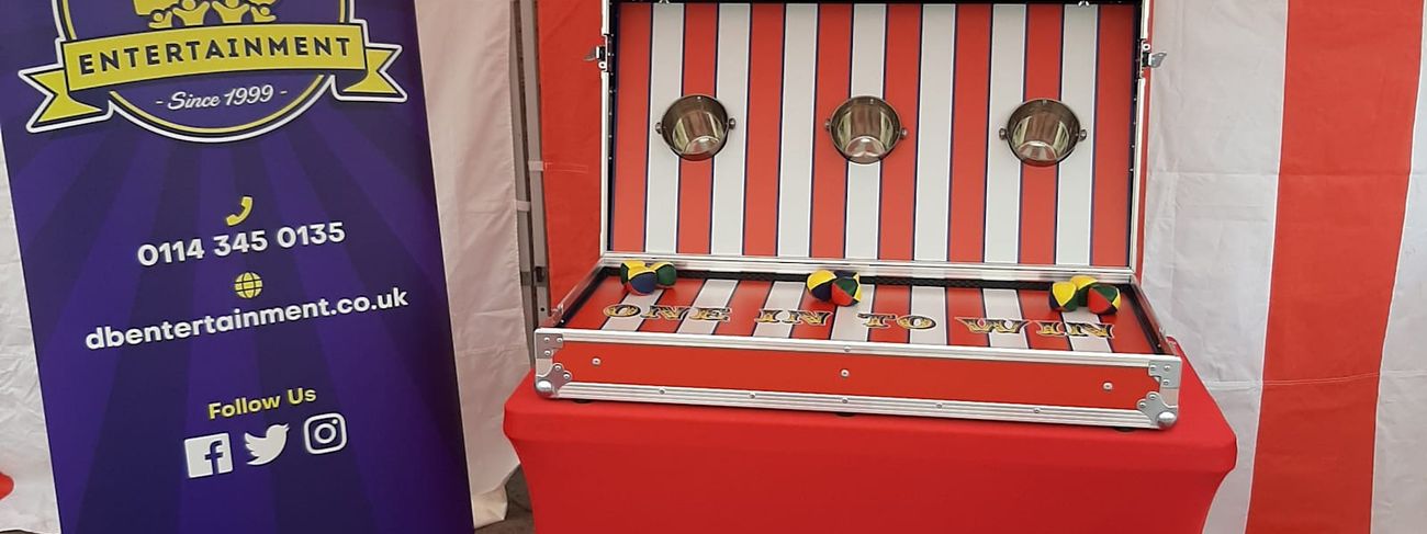 Ball in a Bucket stall under its red and white striped canopy, with the three target buckets mounted on the game board