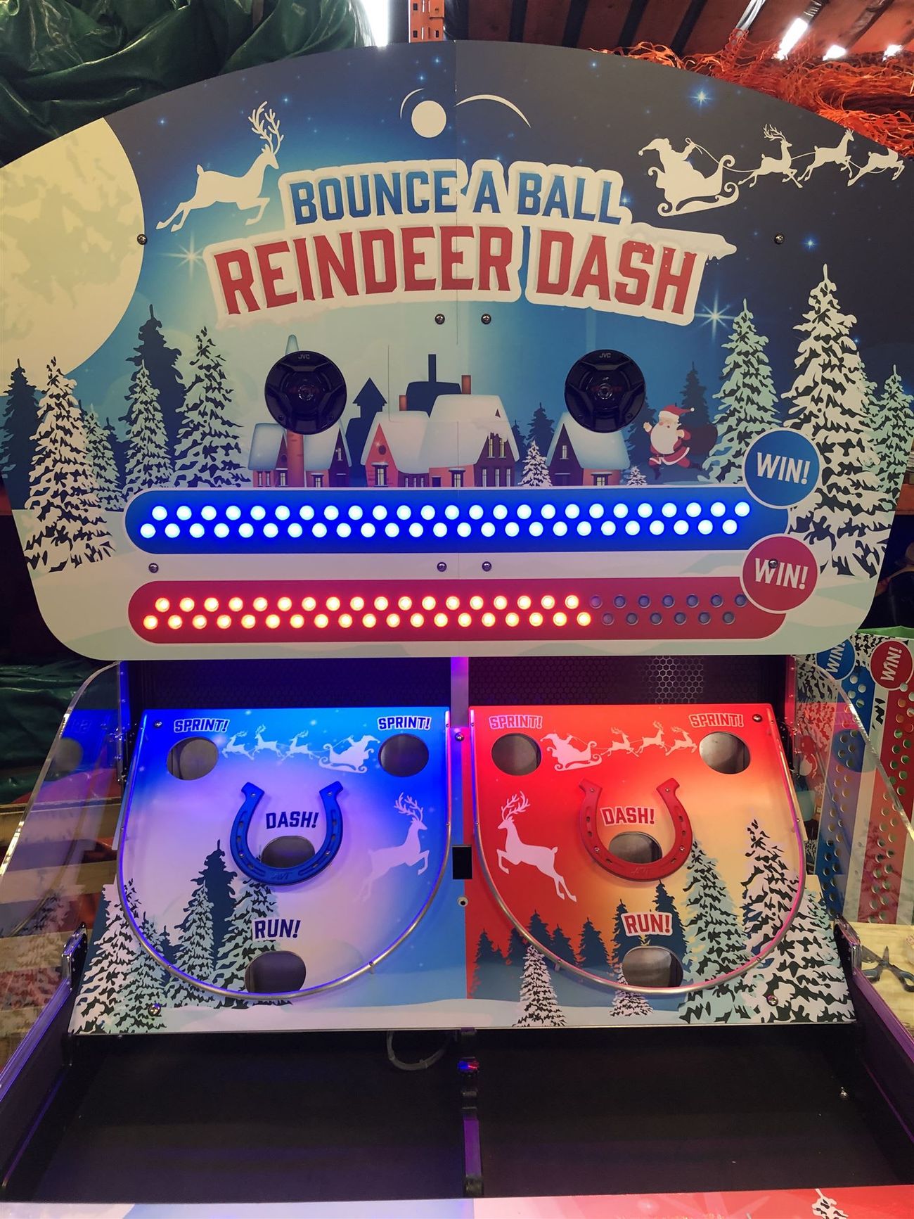 Front view of the Bounce A Ball Reindeer Racing cabinet with blue and red LED scoring tracks lit