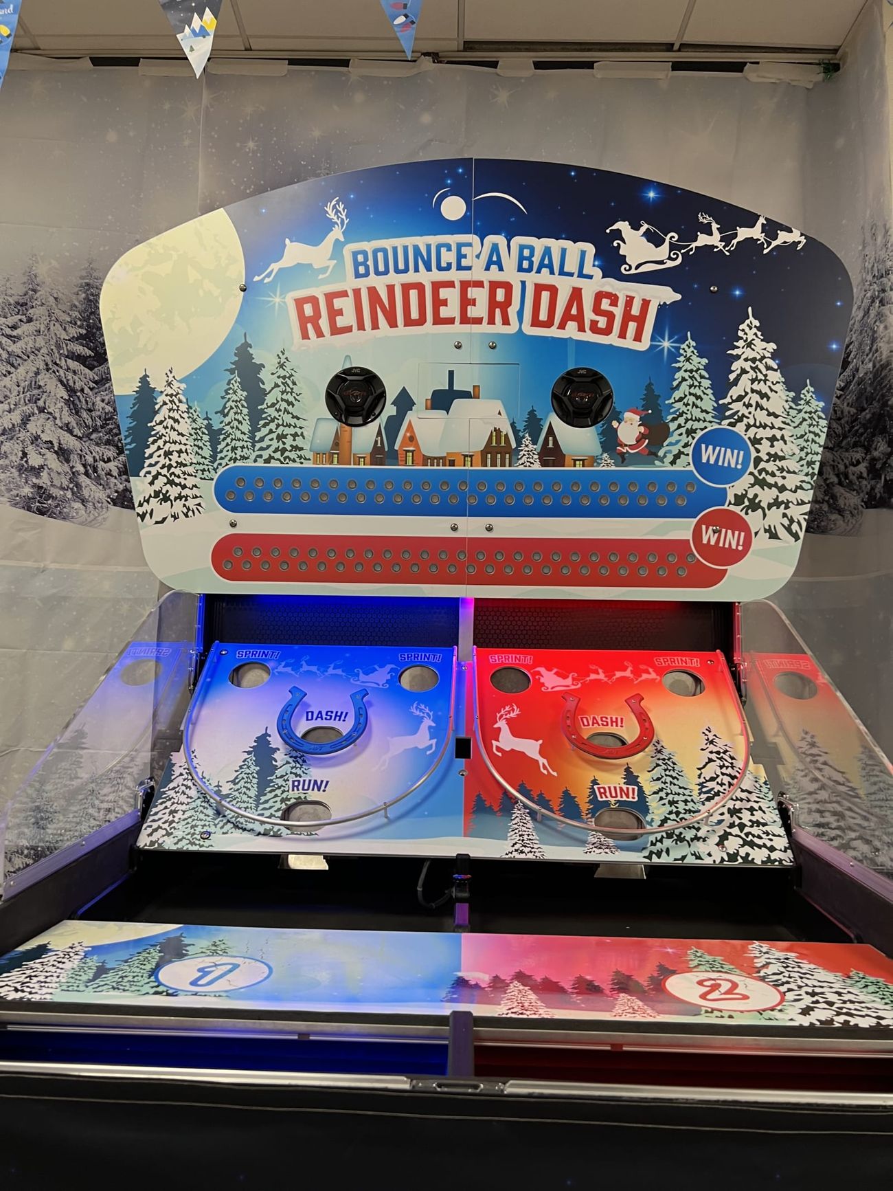 The Bounce A Ball Reindeer Racing cabinet front-on in a decorated festive games room