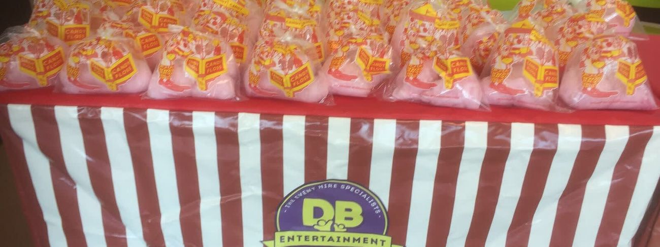 Candy floss and popcorn carts parked together as a combined food row