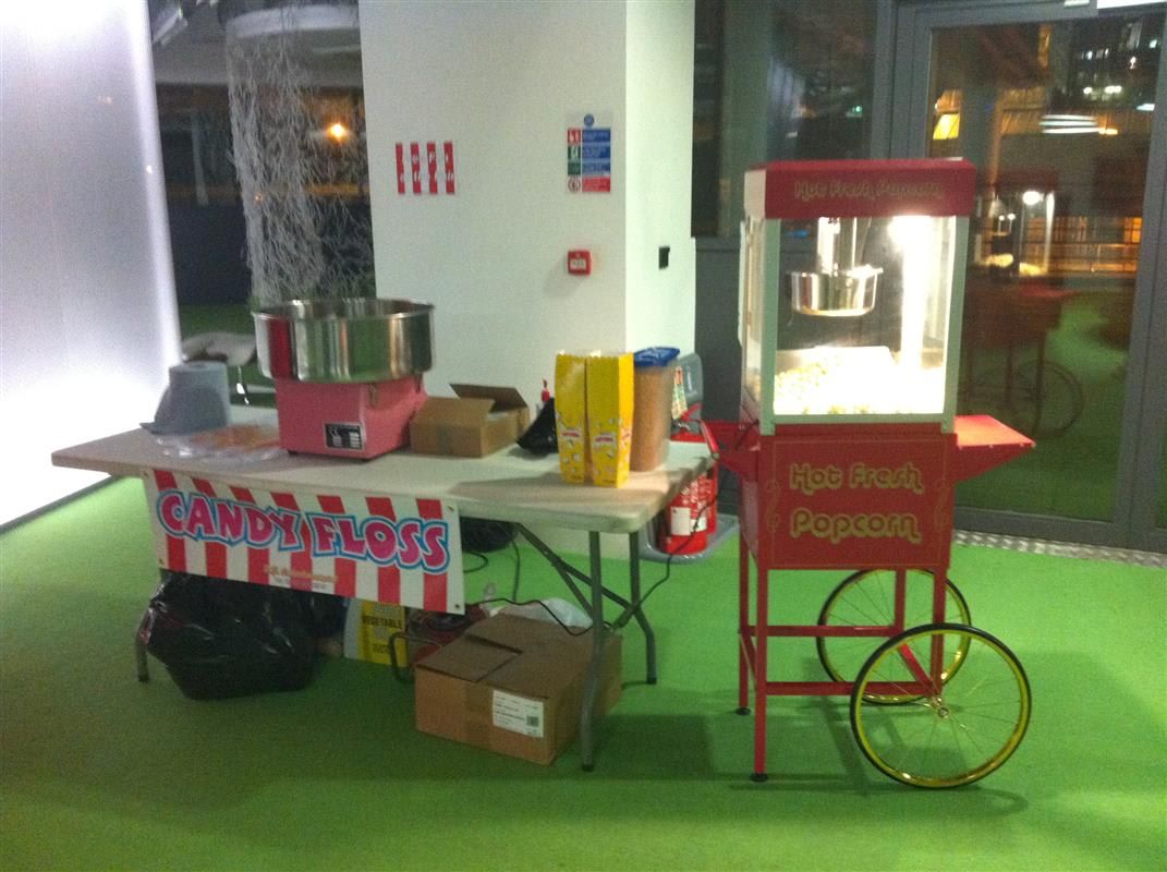 Pre-bagged candy floss portions laid out on the striped serving table