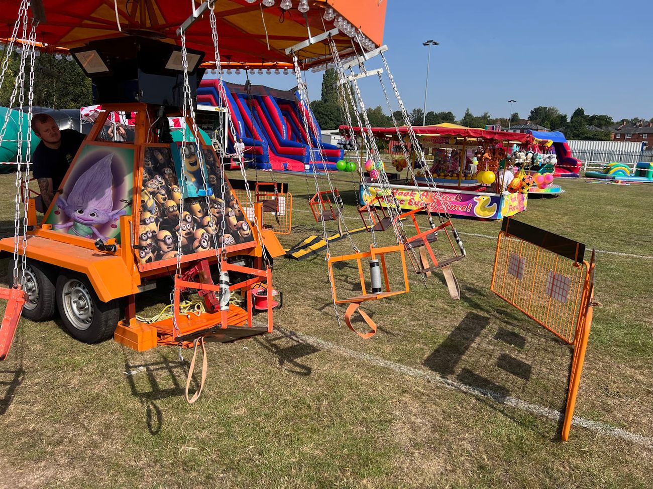 Side view of the Chair-O-Planes showing the swing seats, chains and trailer base