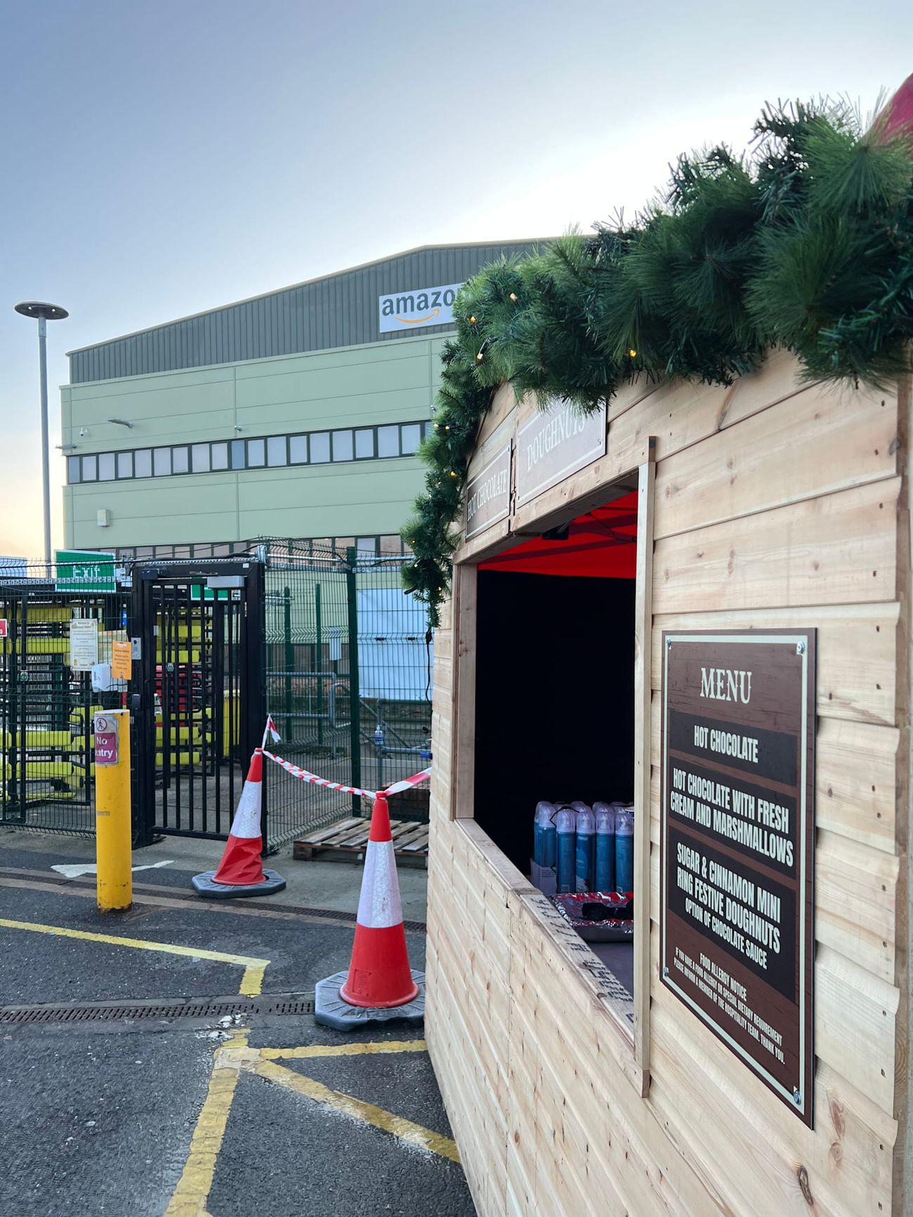A Christmas market stall positioned at a warehouse entrance gate for a staff Christmas event