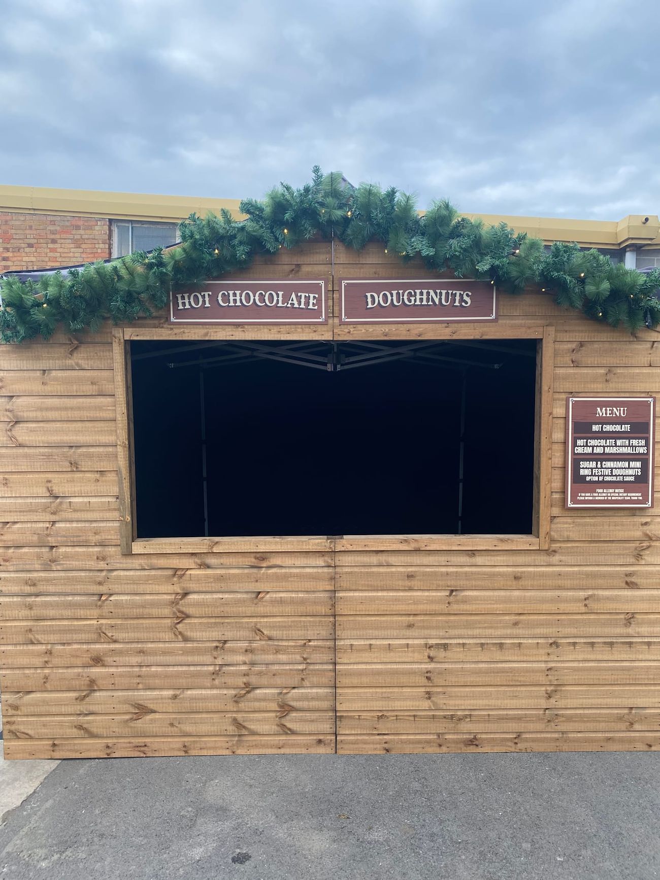 An empty Christmas market stall ready for service outside an event venue