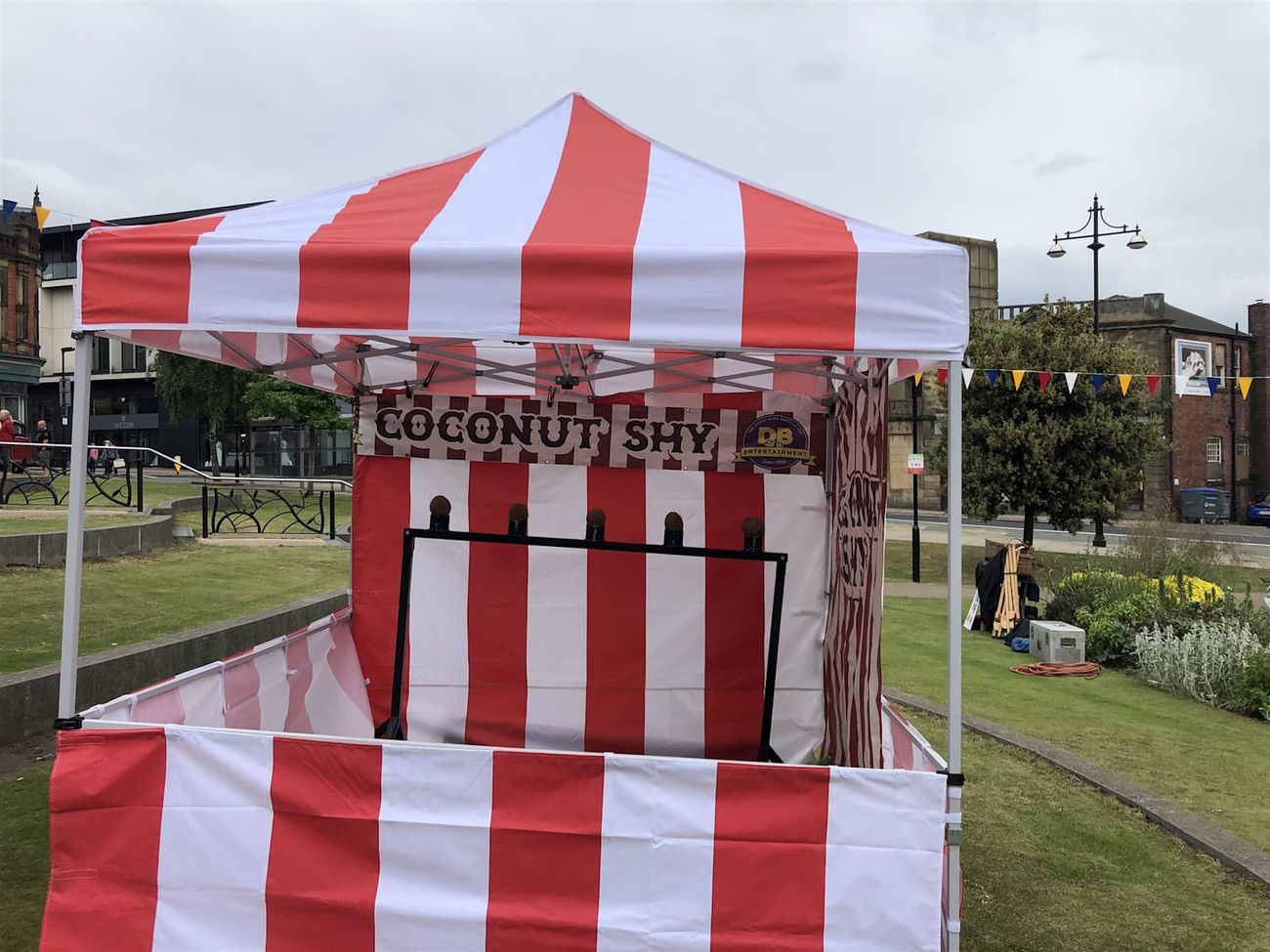 The coconut shy set up on grass at an outdoor event