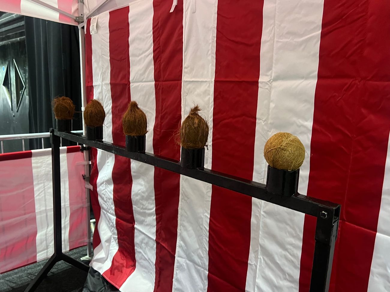 The coconut shy set up inside a venue, showing the stall works on hard standing as well as grass