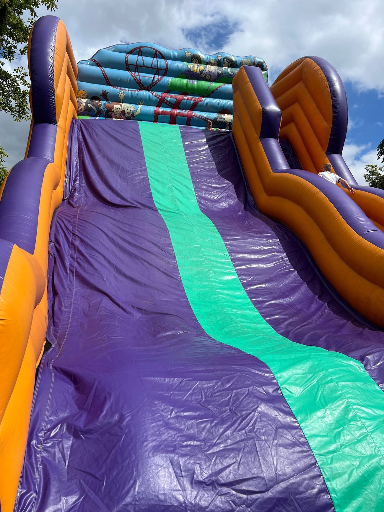 The sliding lanes from below, showing the curved orange bumpers and the scale of the structure