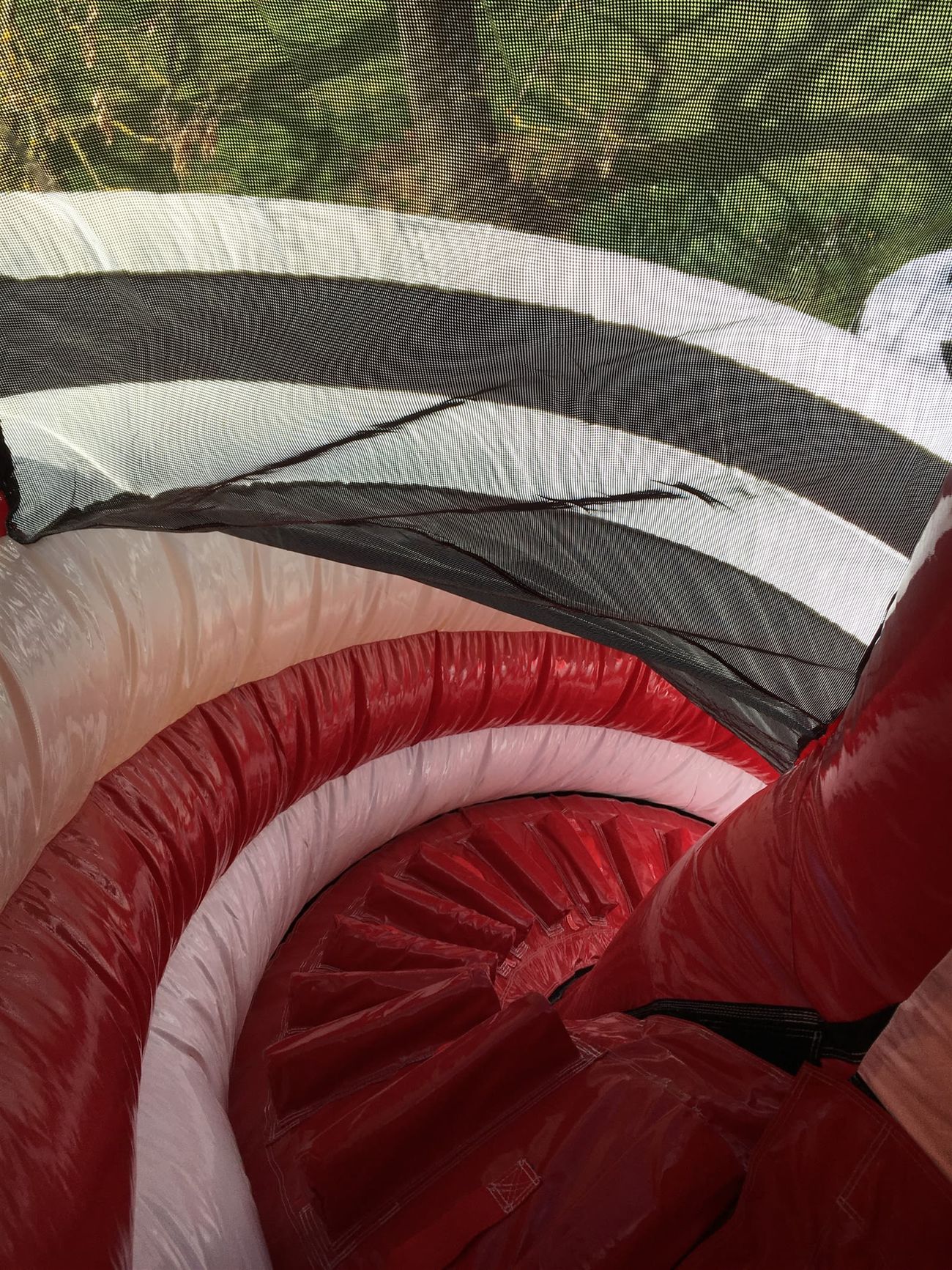 The spiral slide lanes seen from above, showing the netting that encloses riders on the way down
