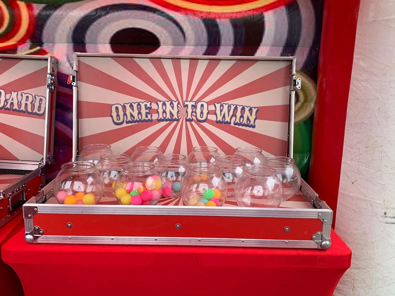 Tin Can Alley with numbered cans stacked in a pyramid and throwing balls in front