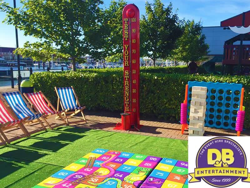 The High Striker set up at an outdoor event alongside giant lawn games and deckchairs