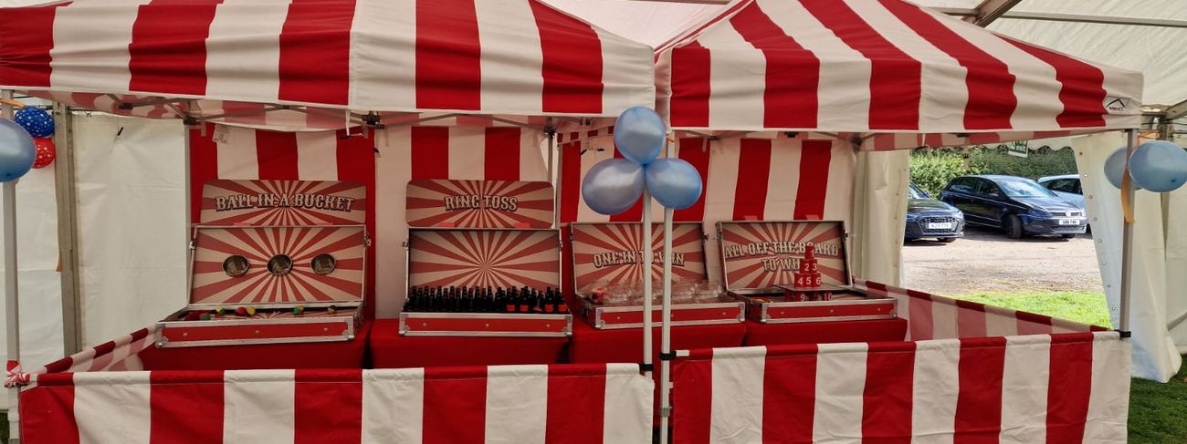 Hook-a-duck stall with its raised pond set up inside an event marquee