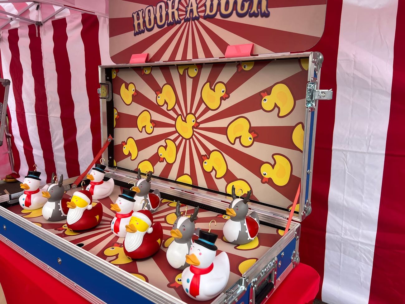 The Hook-a-Duck flight-case unit open for play, with ducks lined up on the board