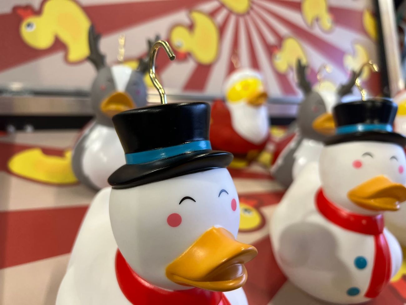 Close-up of a snowman duck in its black top hat with the brass hook on top