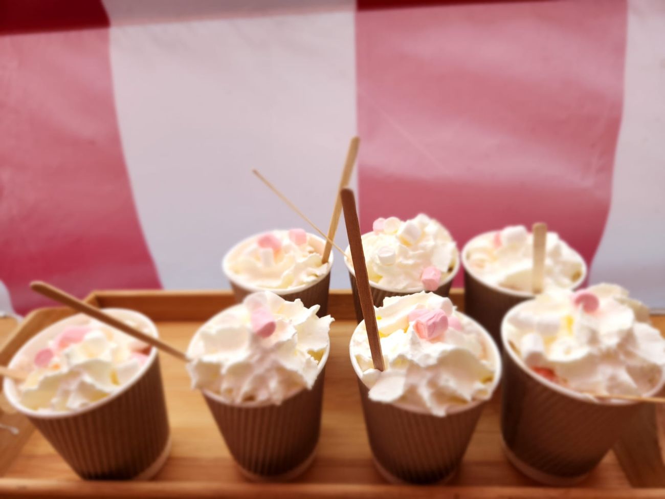 Paper cups lined up on a tray, ready for the server to fill