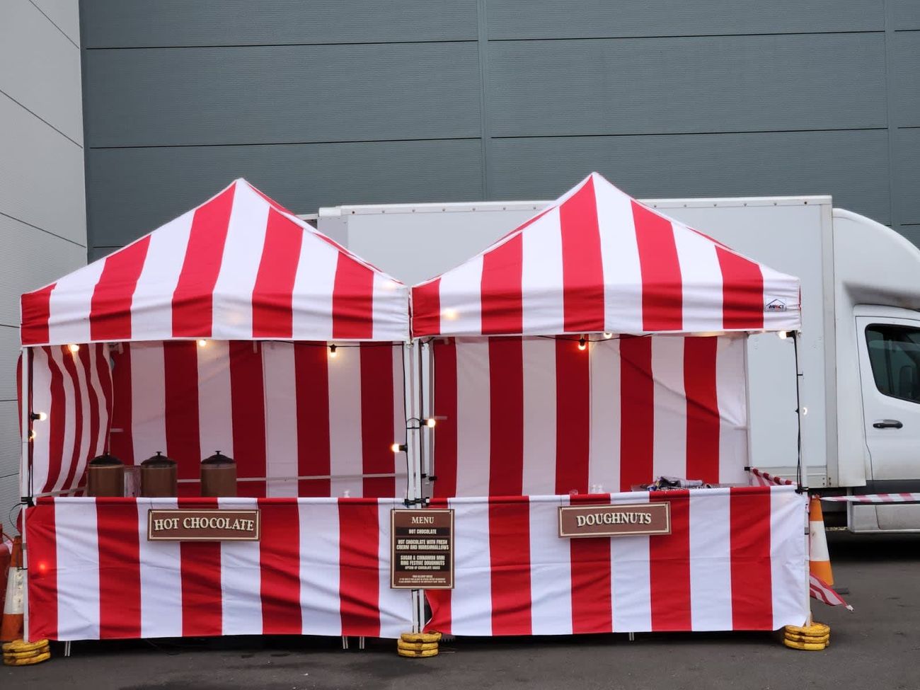 The hot chocolate stall set up under pop-up canopies at an outdoor event