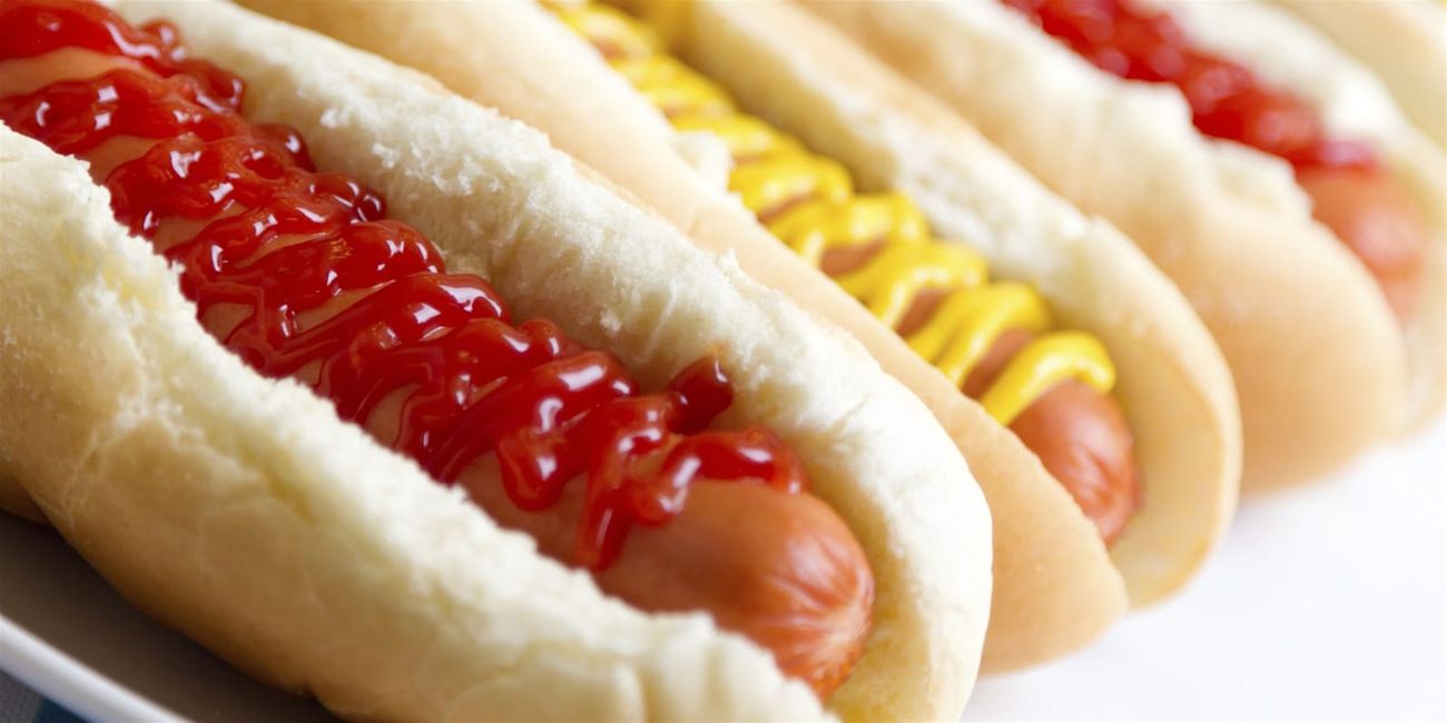 A row of jumbo Frankfort hot dogs in giant buns, ready to serve