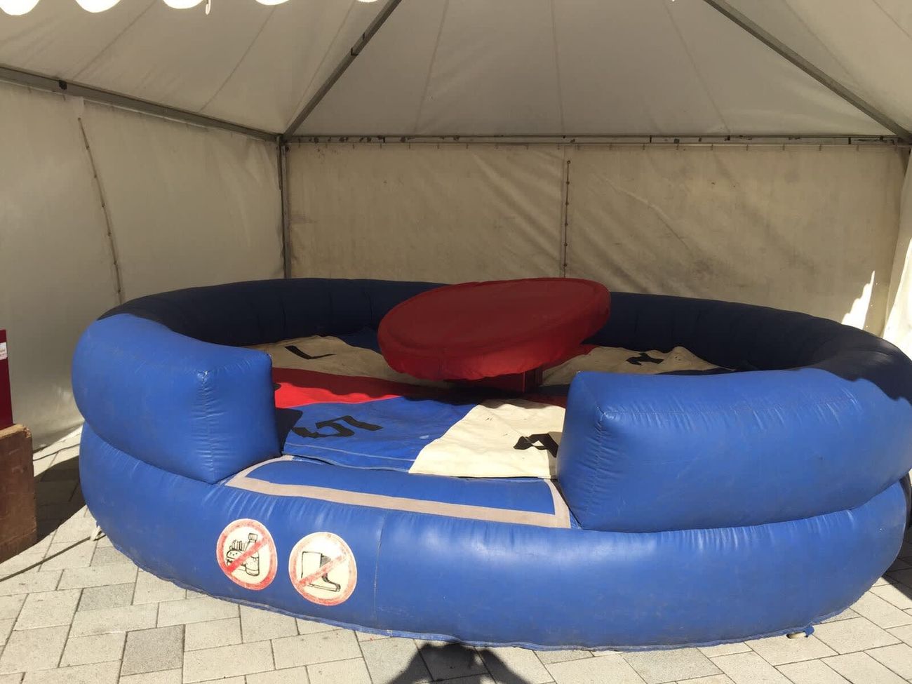 The Human Roulette inflatable structure with its blue outer ring and central spinning disc