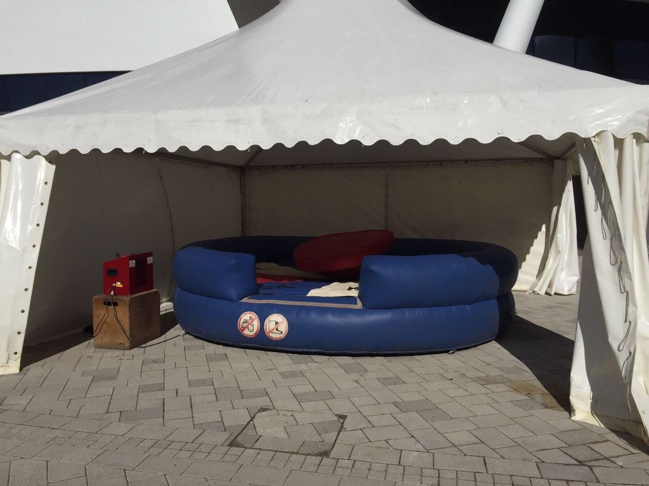 The roulette set up under a white canopy at an outdoor event on a sunny day