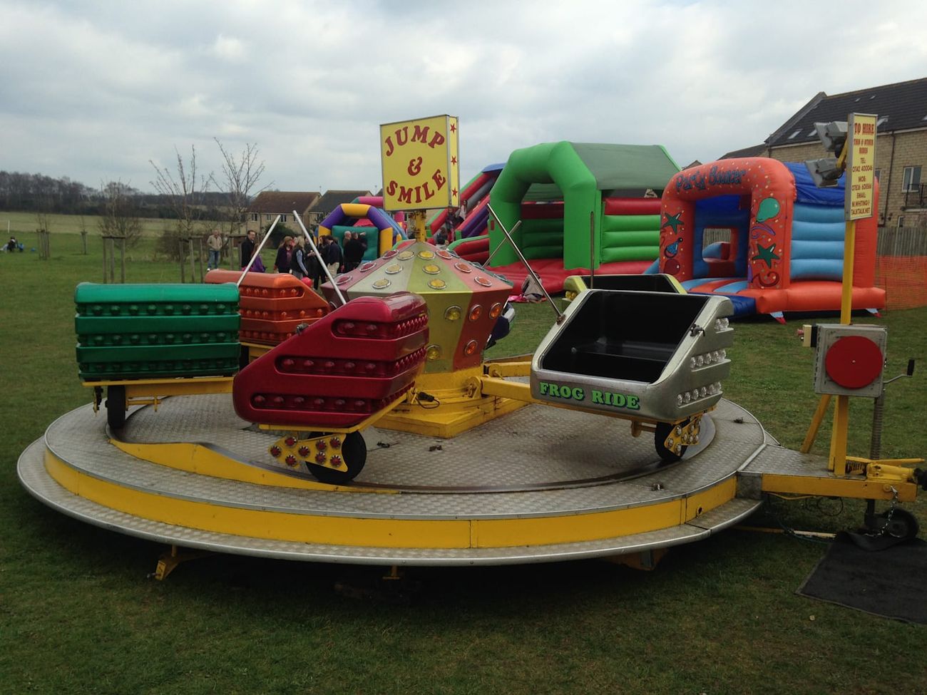 The ride on its yellow trailer frame, set up on a grass field