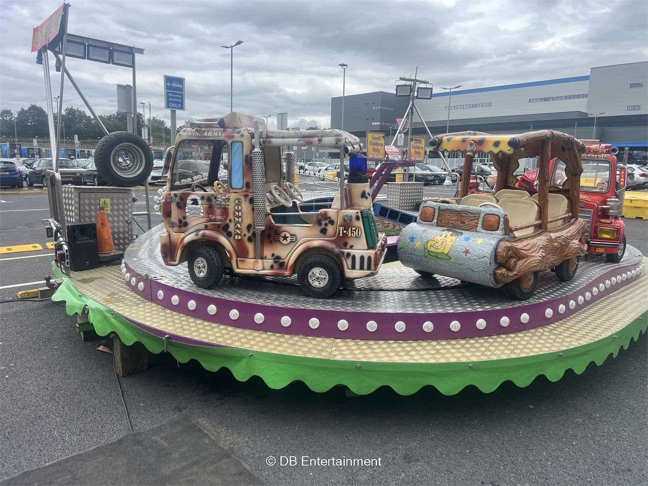 The camo army truck and the Flintstones-style car with its log roof on the bulb-lit platform