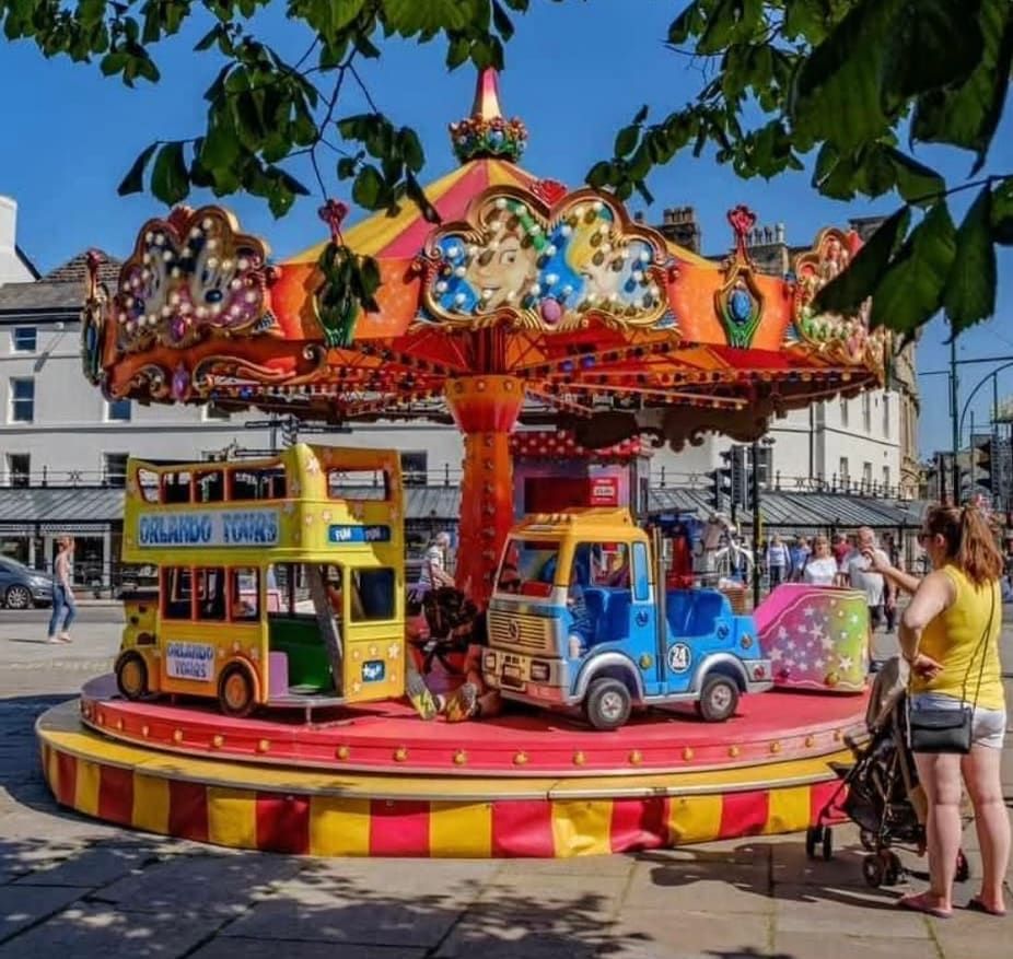The large toy set with the open double-decker Orlando Tours bus and the number 24 toy truck on the red deck, under the red and yellow striped canopy