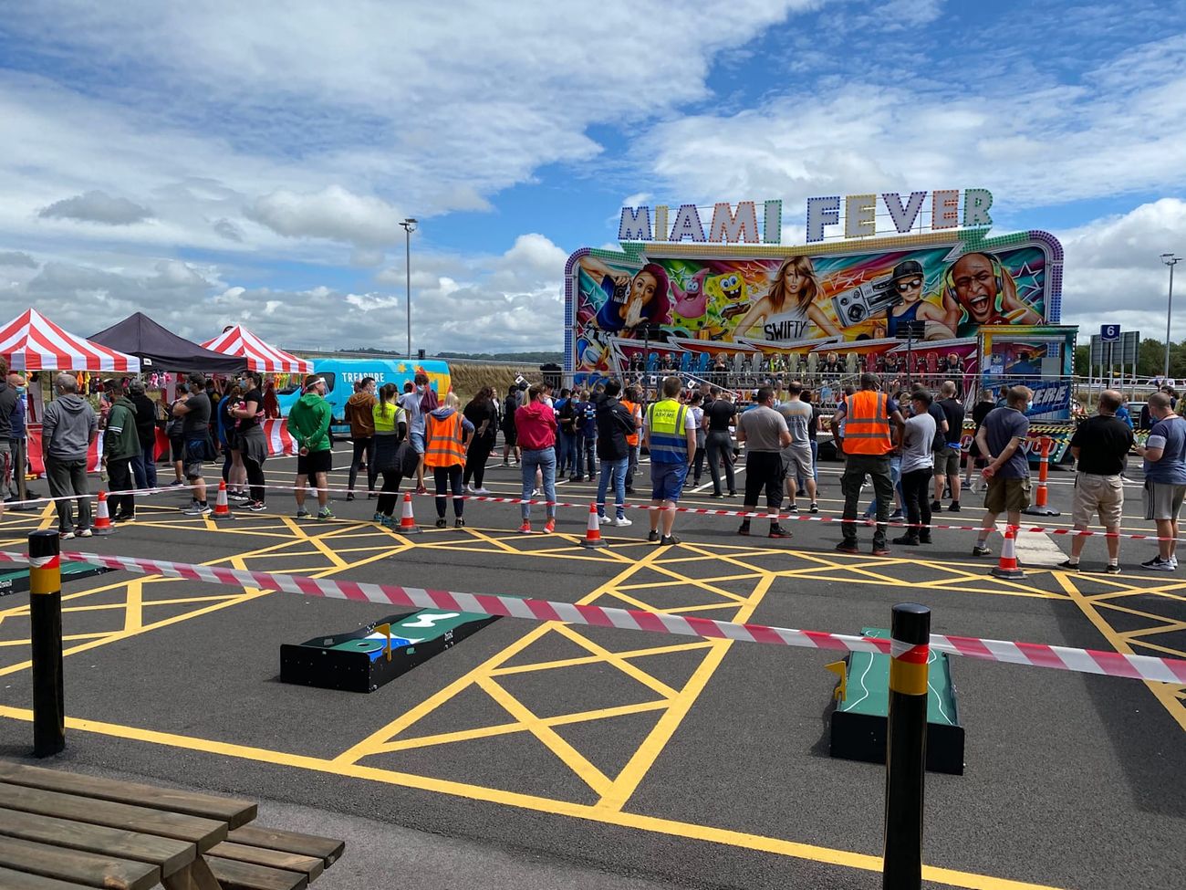 Full-width view of the Miami Fever ride on hard standing with its bench, central steps and painted frontage
