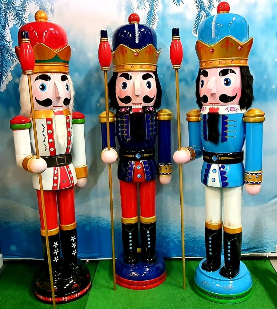 Three giant nutcracker soldiers in red, navy and light blue colour schemes