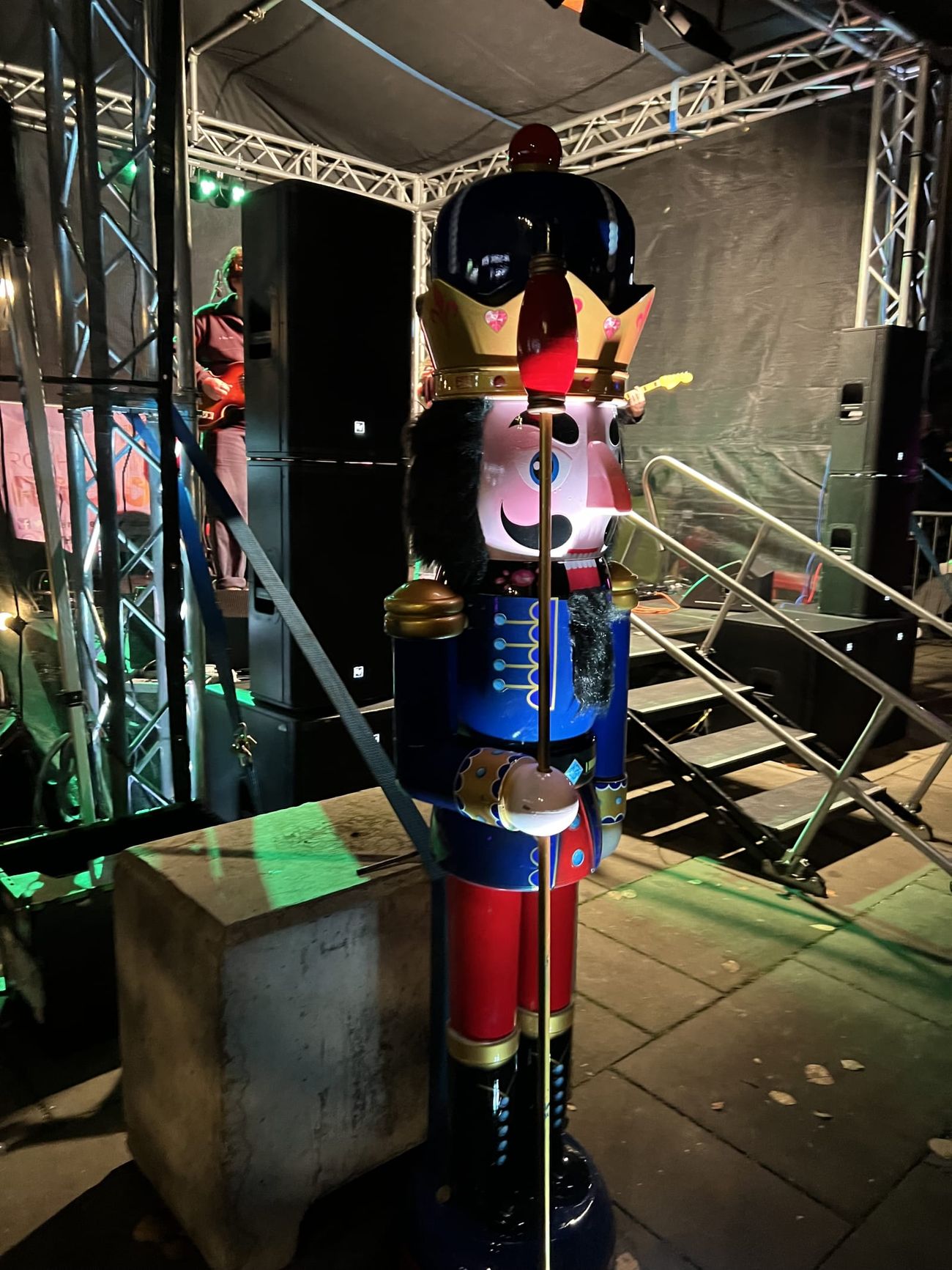 A nutcracker prop on a lit night-time event stage