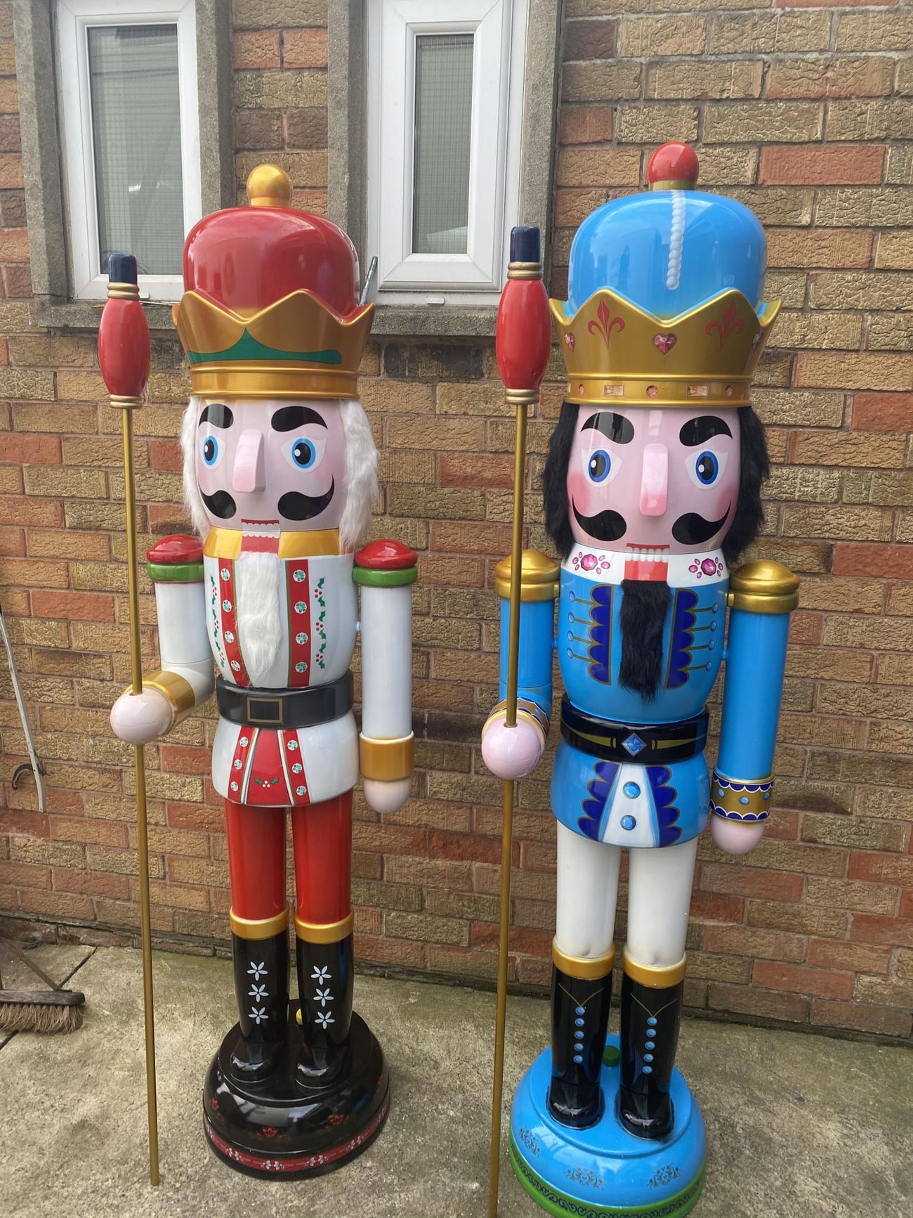 Red and blue nutcracker trail figures positioned against town-centre brickwork