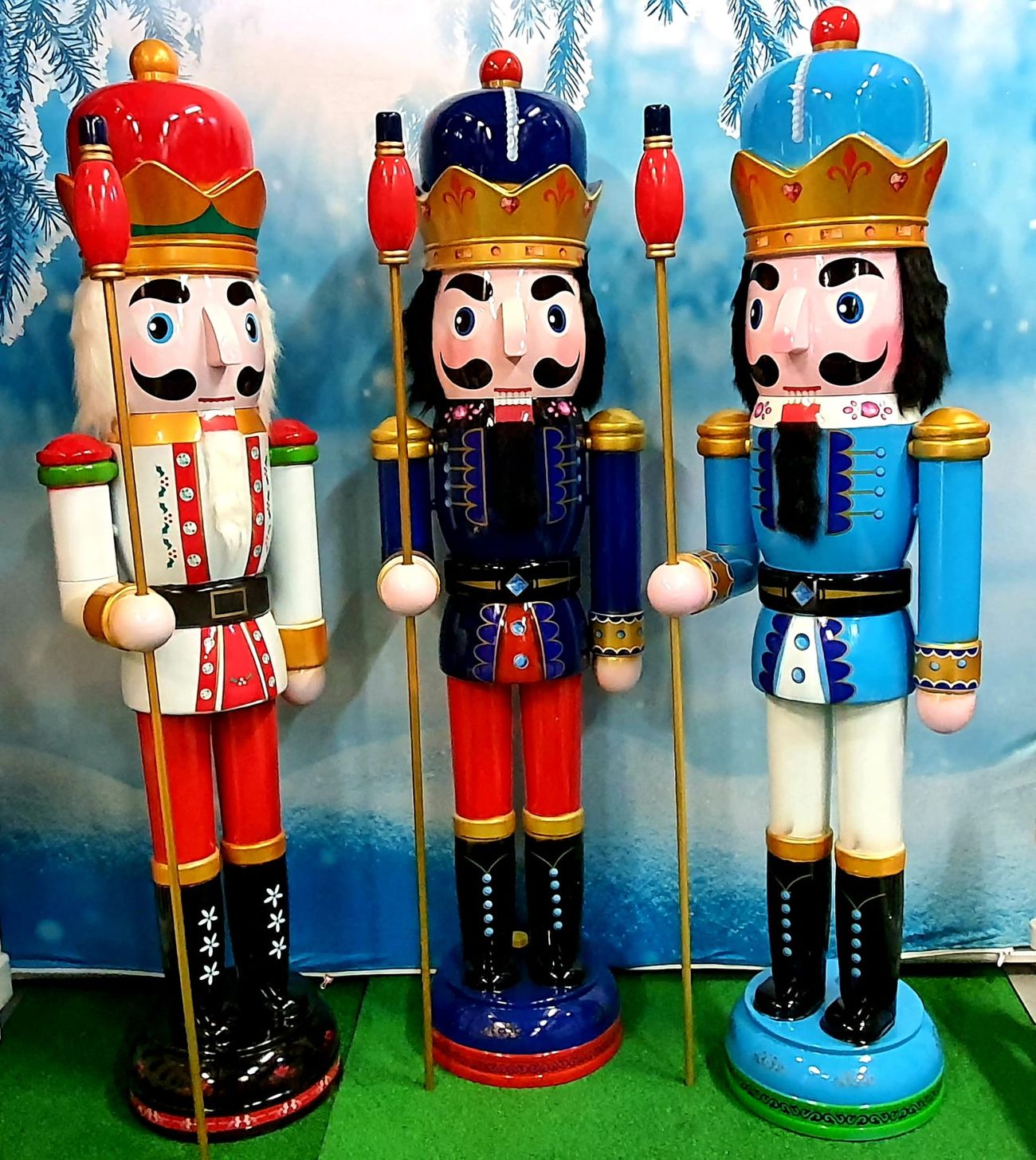 Three six-foot nutcracker trail figures in red, blue and light-blue uniforms