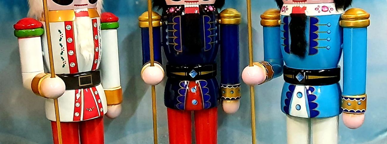 Three six-foot nutcracker trail figures in red, blue and light-blue uniforms