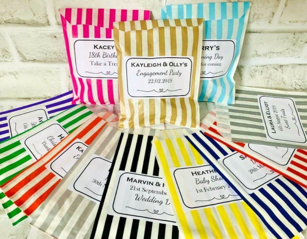 Personalised paper bags for guests to fill, laid out beside the stand