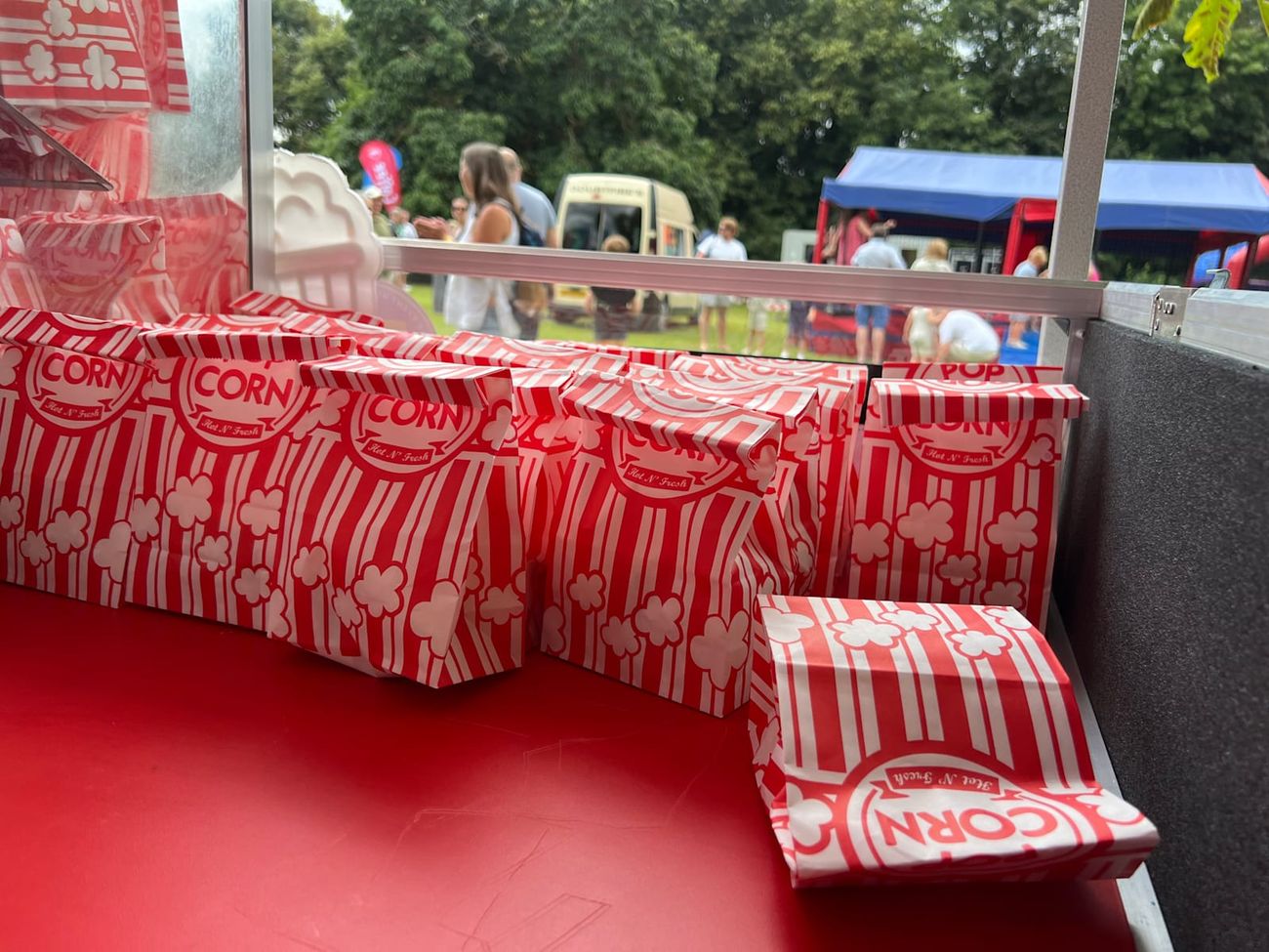 Retro red and white striped popcorn bags on the serving counter, ready to fill