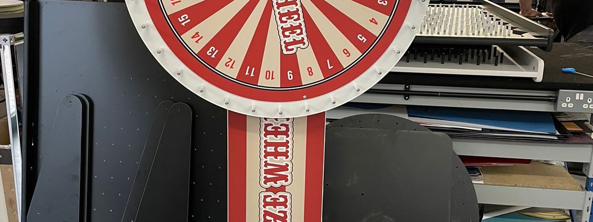 Classic carnival prize wheel with its painted segments and pointer