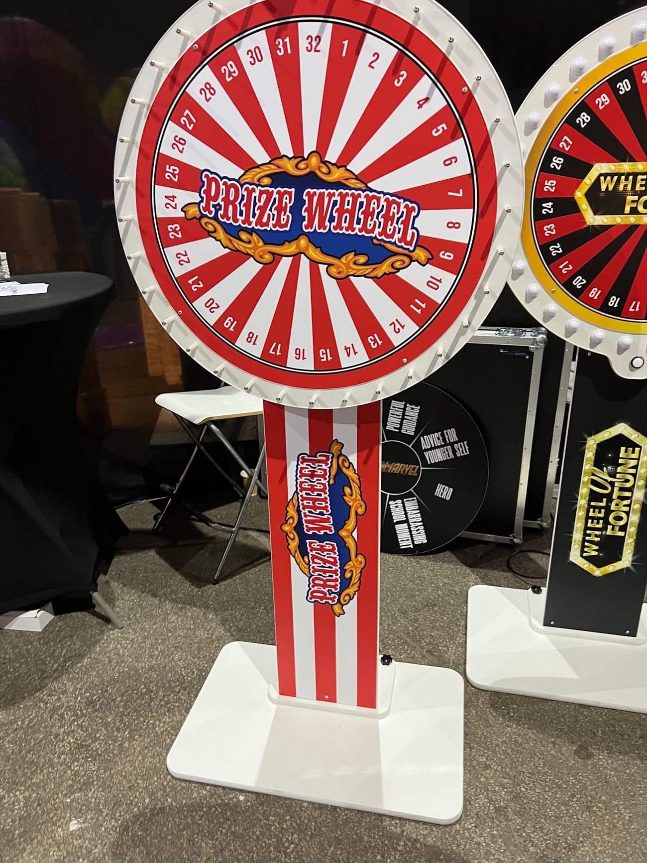 Prize Wheel freestanding on its white plinth with the striped column and pointer flapper at the top