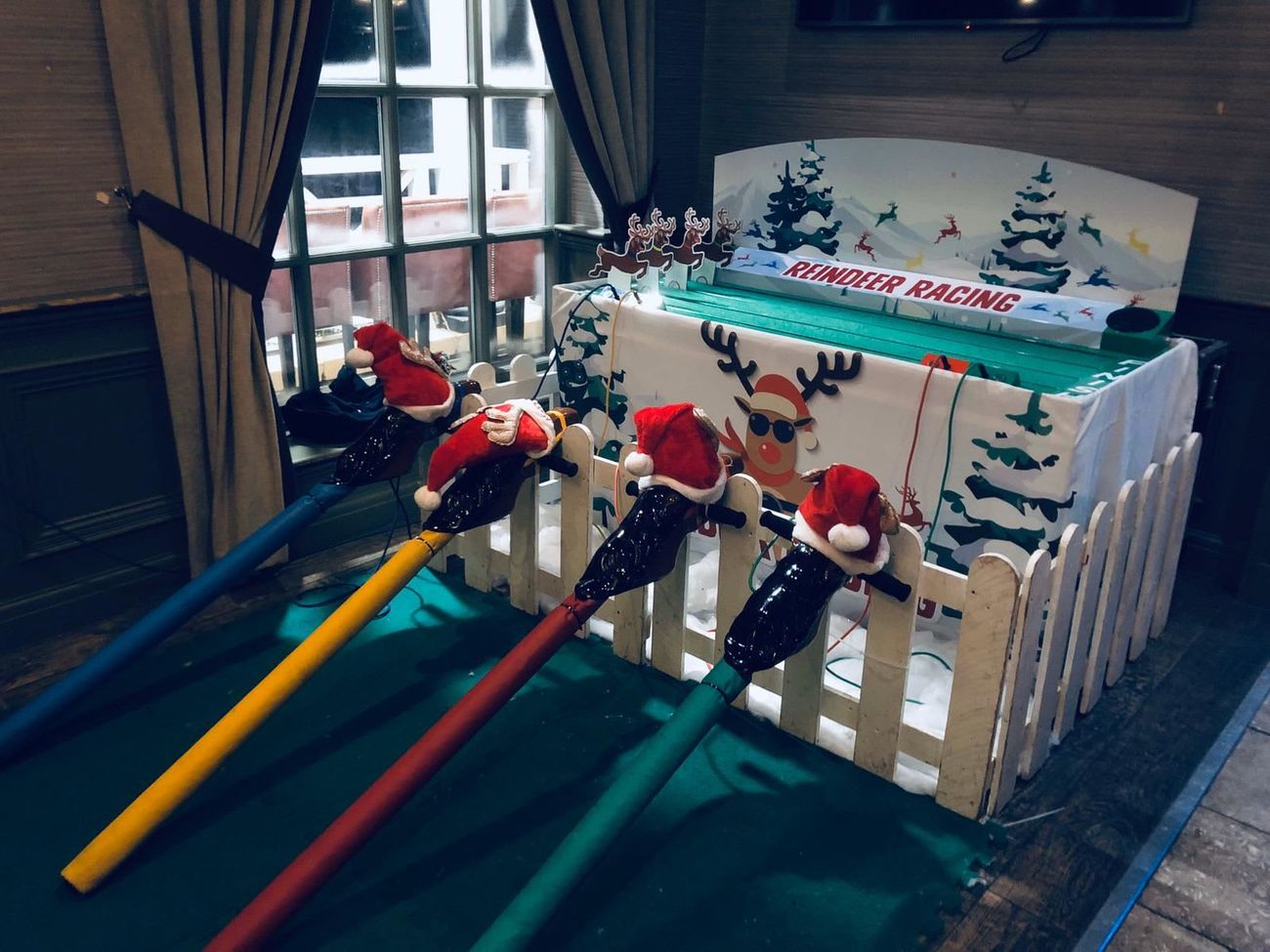 The full Reindeer Racing setup with the track lit for an evening event