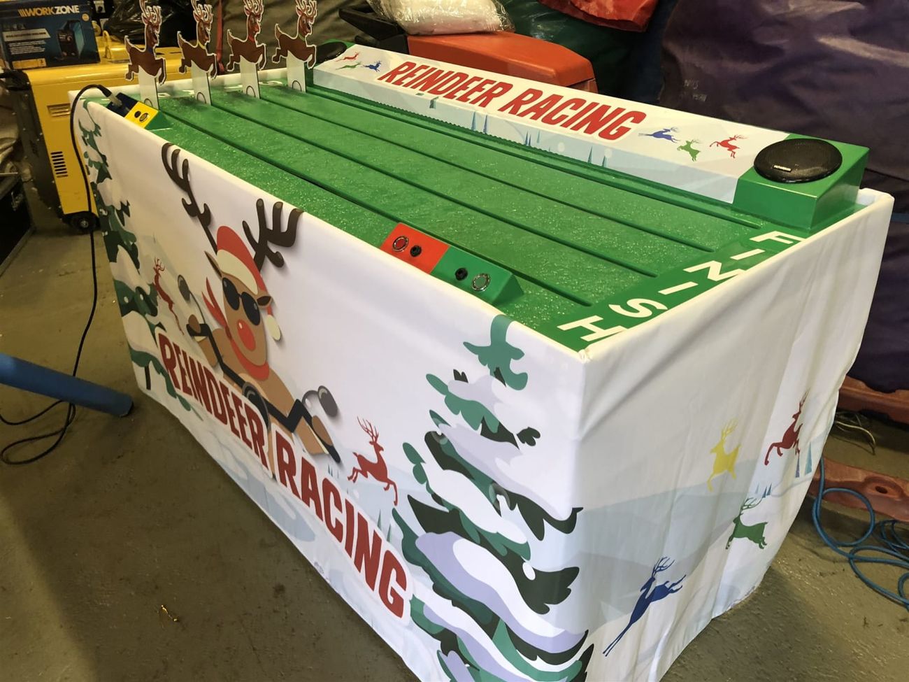 Wide view across all four colour-coded Reindeer Racing lanes at a Christmas event