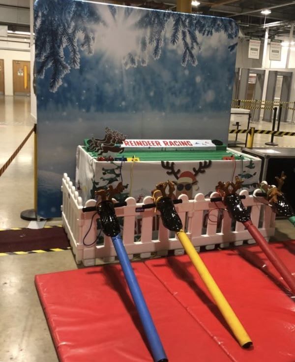 The Reindeer Racing game with its white picket-fence surround and printed snow-scene backdrop