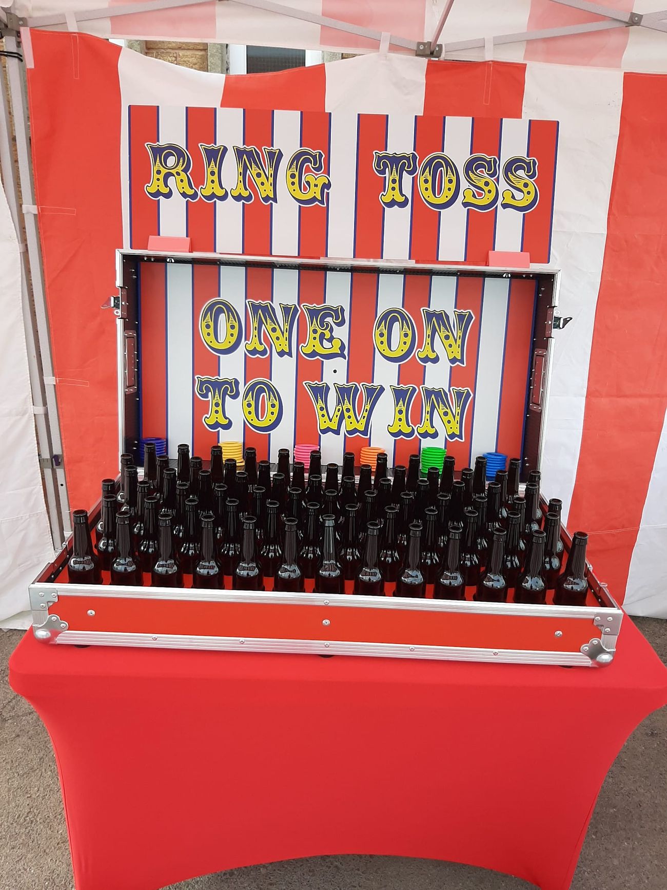 The Ring Toss flight case opened for play, with rows of bottles and the throwing rings beside them