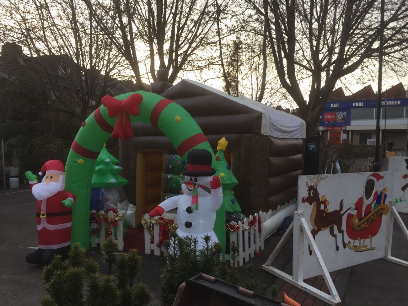 The log-cabin Santa's grotto with its chimneystack and wreath arch