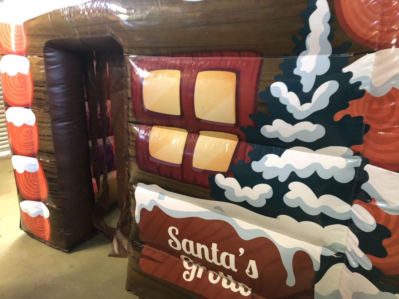 Side panel of the Santa's grotto with its lit window and snowy pine print