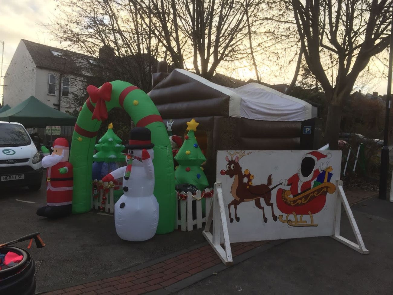 The wreath arch entrance of the Santa's grotto with the freestanding Santa and snowman props