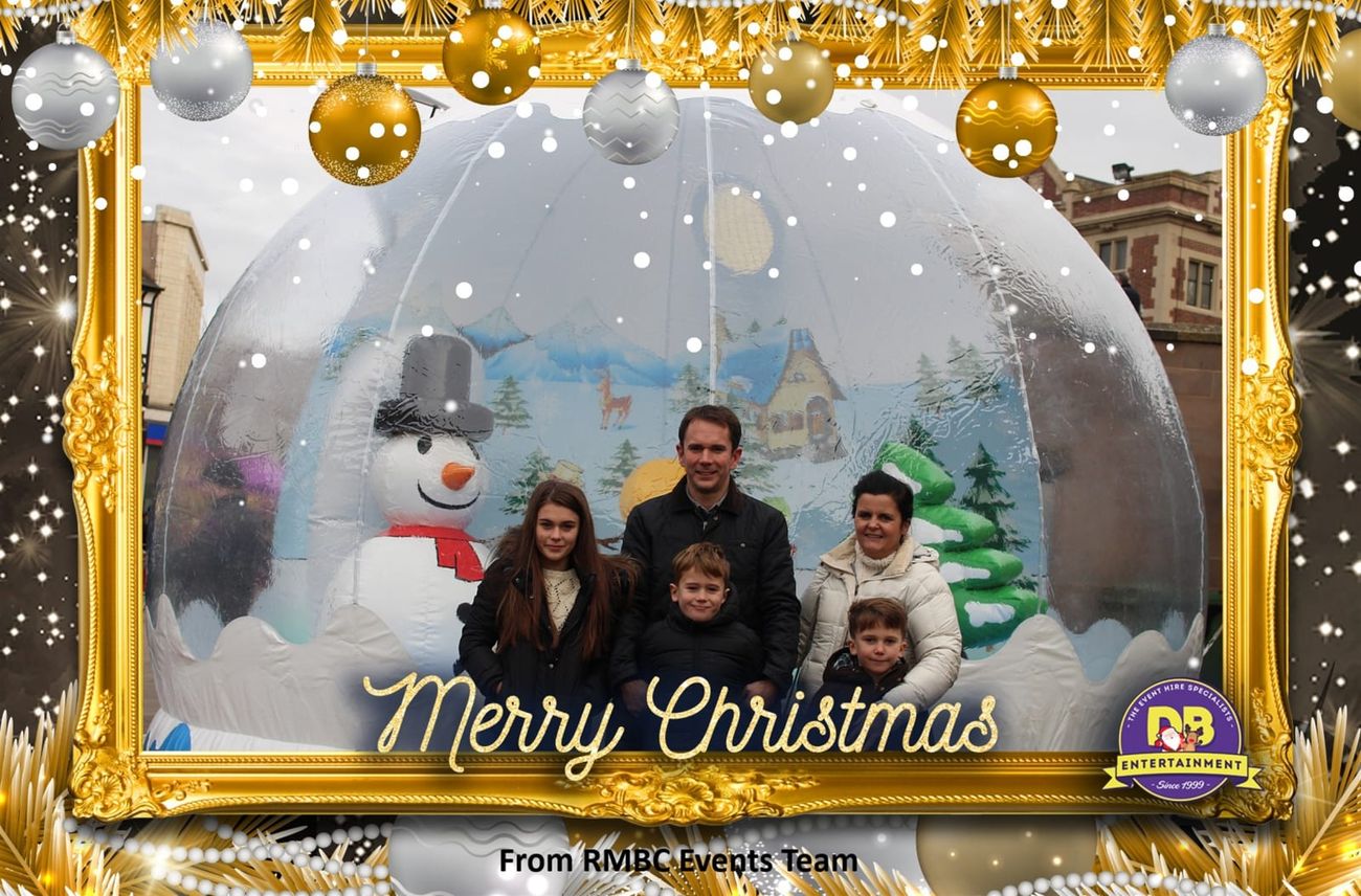 A family photo printed in the gold Merry Christmas frame with its bauble border