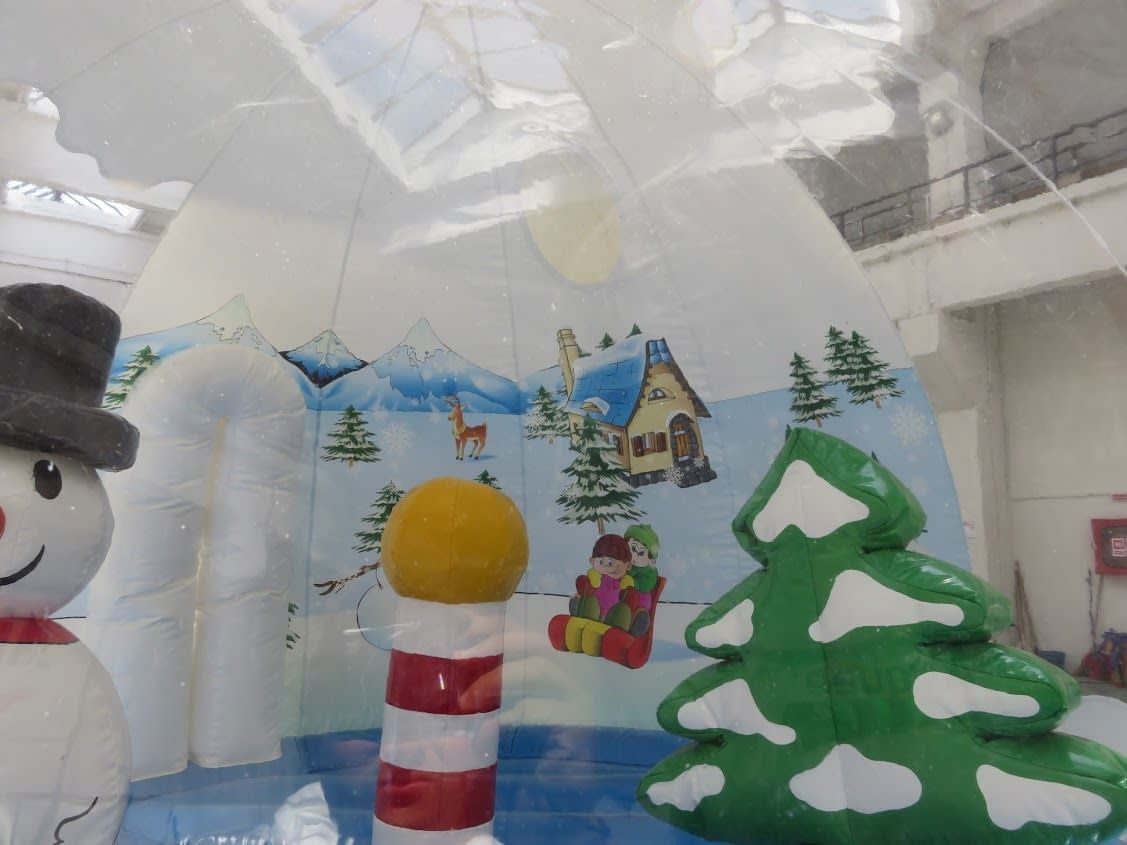Detail of the snow globe pod's painted backdrop with alpine cottage, sledging children and deer