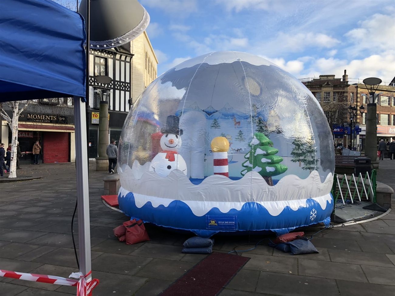 The snow globe pod in a town square with a red carpet leading to the entrance