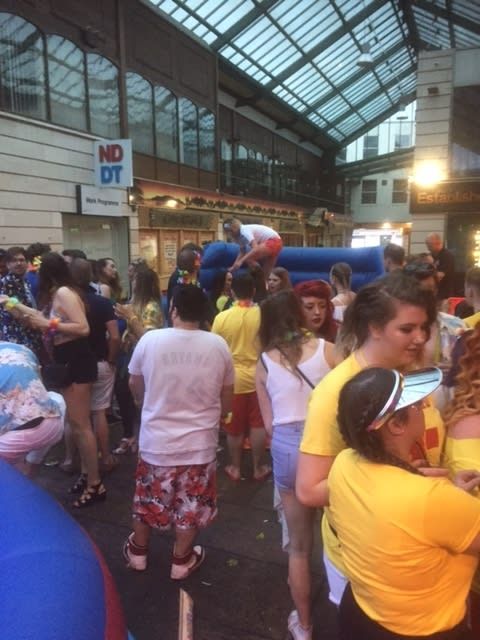 The surf simulator set up at a bustling indoor venue