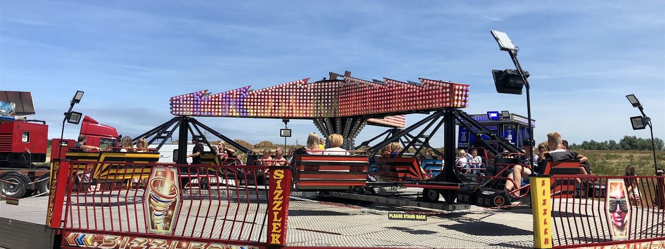 Twister ride in motion with riders on the full platform